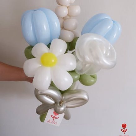 A small bouquet of white daisies and pale blue tulips with a silver bow.