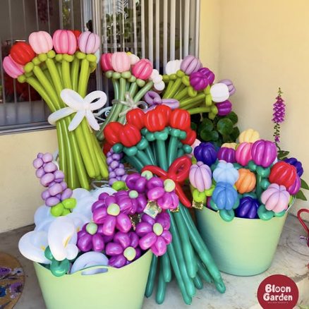Buckets of balloon flowers in many colours, ready for an event.